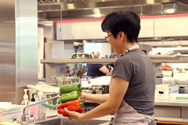 woman washing peppers