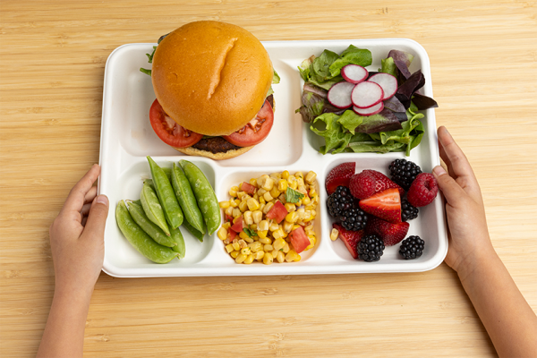 lunch tray held by student